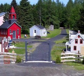 Place des Pionniers, a replica of the Acadian village of Saint-François with several small colorful buildings