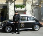 A police officer standing in front of the Saint John Police Museum