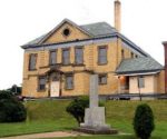 The Restigouche Regional Museum, a large yellow gabled building