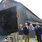 Members of AHNB stood in front of the Patrick Owens Covered Bridge. 